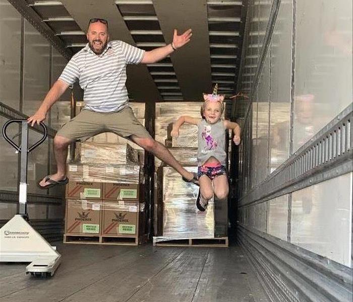 Man and Child jumping in a trailer