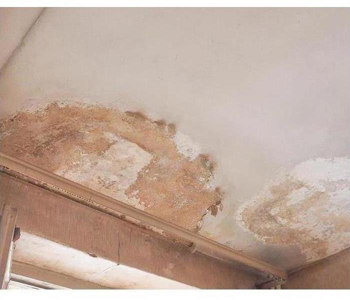 A ceiling with water damage. A big brown spot