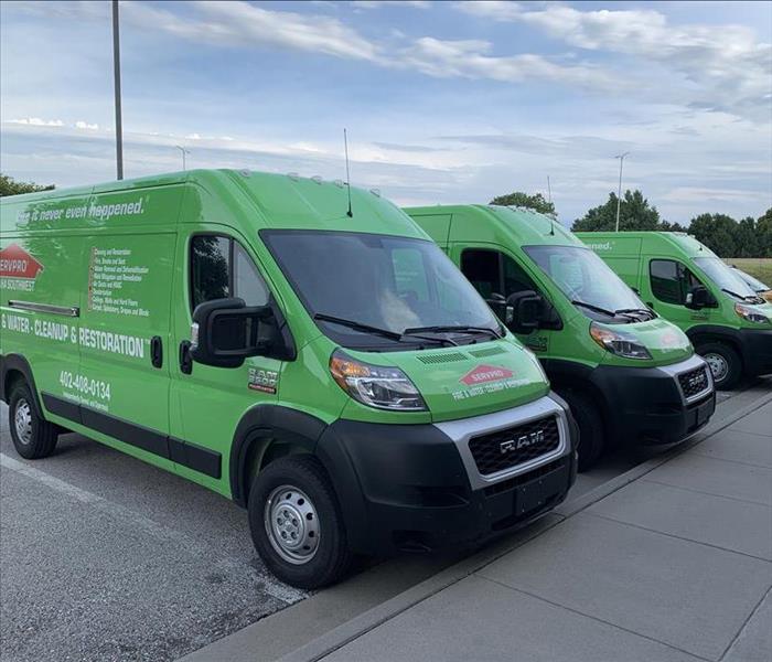 Three green SERVPRO vans