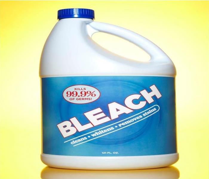 A non-branded 121 FL OZ. bleach bottle on a yellow background.